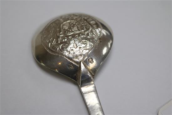 An Indian white metal pouring vessel and a continental apostle spoon.